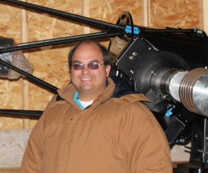 Ruben standing in front of his favorite telescope